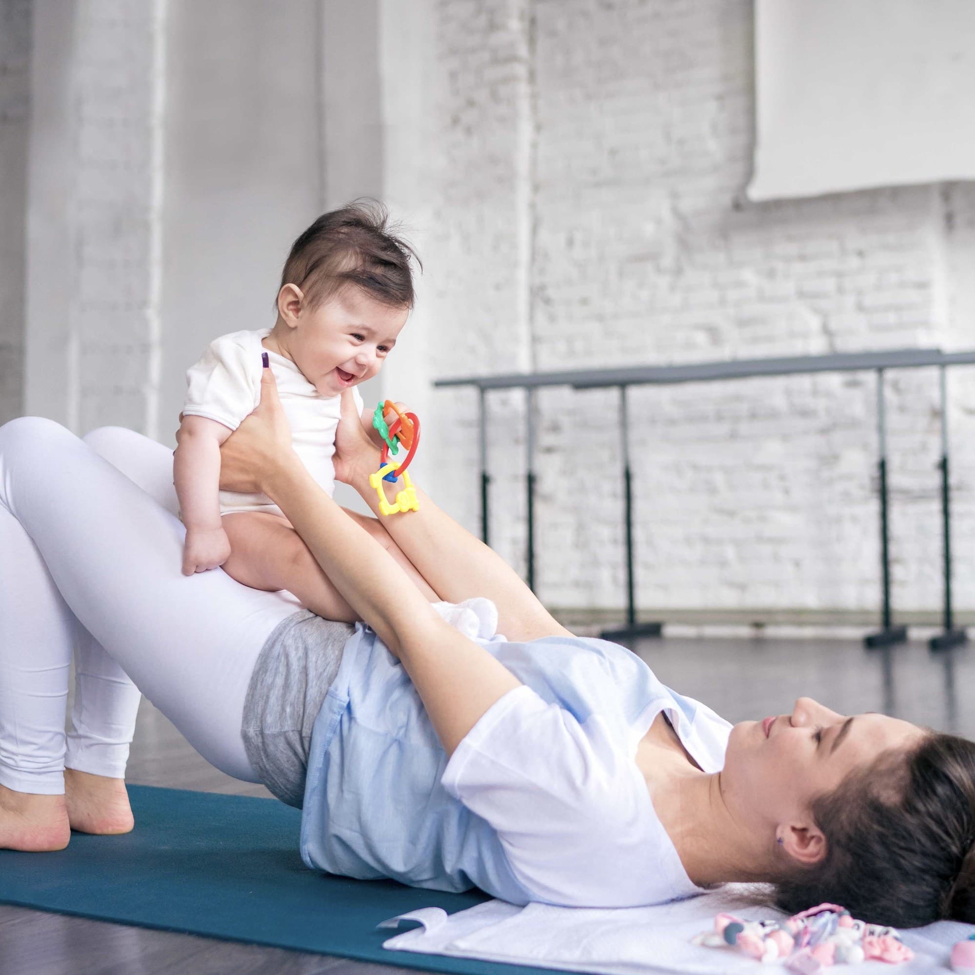 A parent lifting their baby during a Startstrong Fitness CIC class